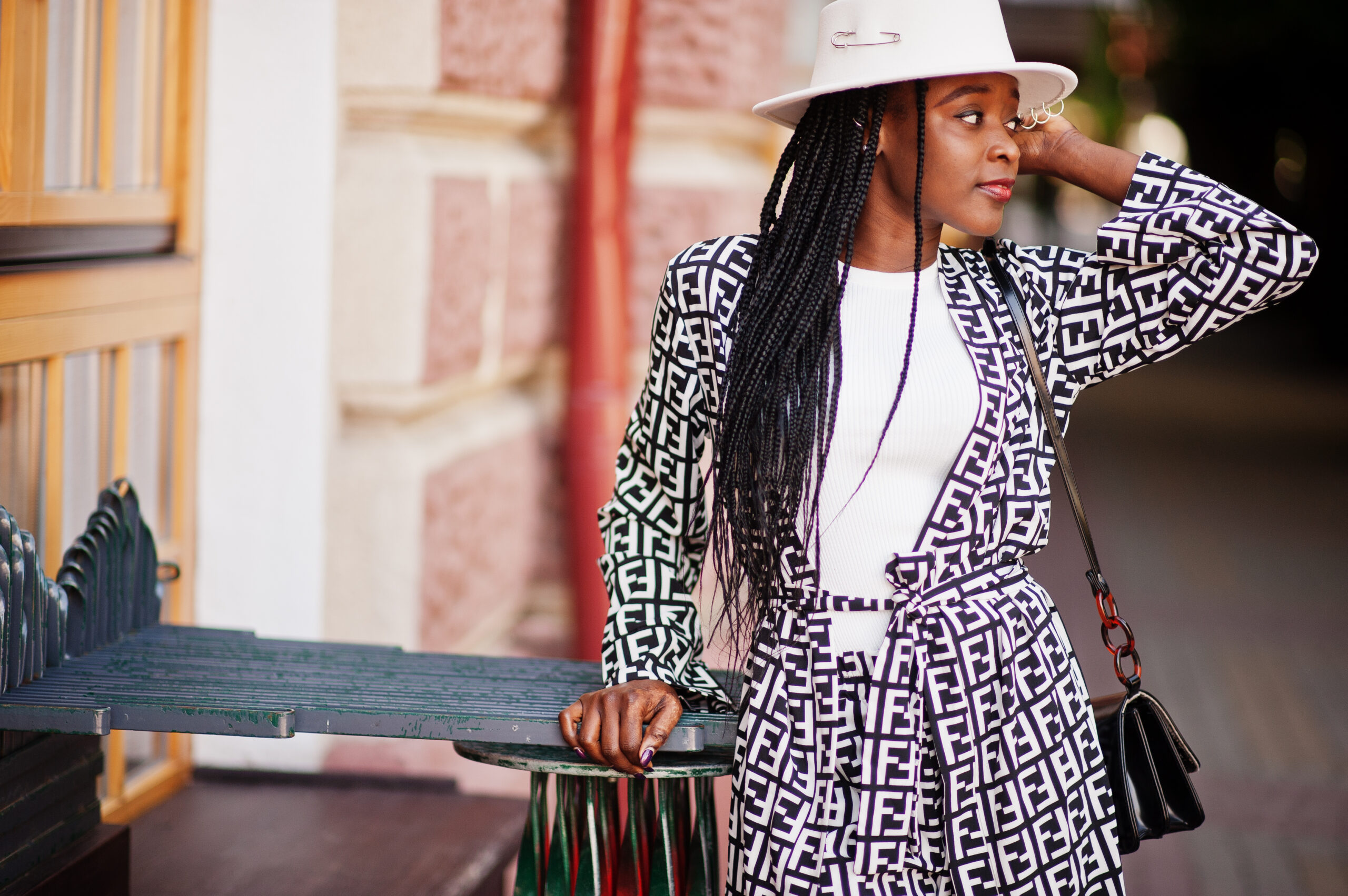Beautiful african american woman natural makeup wear fashion clothes casual black and white dress code office style total blouse and pants suit and hat.